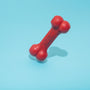 red Kong bone figure on teal surface