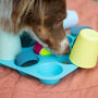 a dog playing with toys on a bed