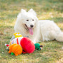 A white dog rests with its colorful toys.